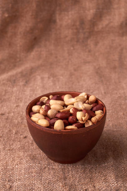 istock walnut peanut in clay bowl. peanuts for food textures. peanut harvest. fried peanuts. texture of the nuts. photo for layout. Copyspace 1021625468