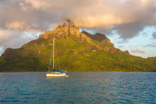 Morning sun on Mount Otemanu Early morning in the lagoon at Bora Bora. Leeward island of French Polynesia, South Pacific. sailboat mast stock pictures, royalty-free photos & images