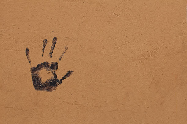 istock Traces of black hands on the wall 1 1021629360