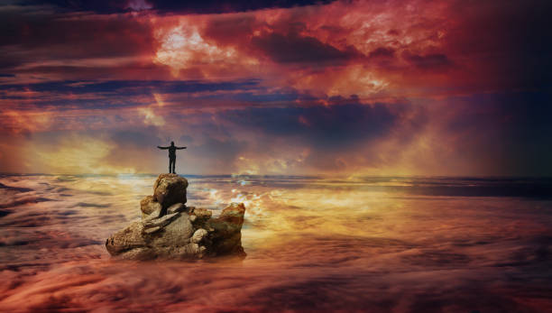 istock A man on a rock above the clouds 1 1021629494