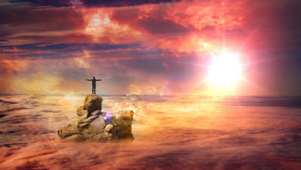 istock A man on a rock above the clouds 3 1021629502