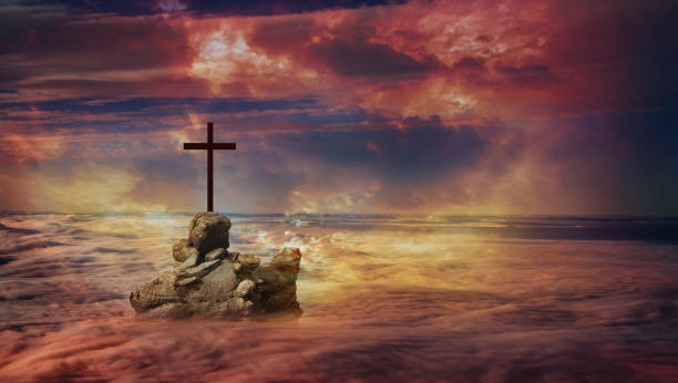 istock Cross on a rock above the clouds 1 1021629522