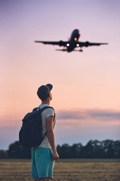 istock Traveler is looking at the landing airplane 1021632284