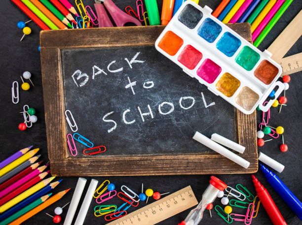 istock Back to school Background. School supplies on black chalk board. Flat lay 1021643978