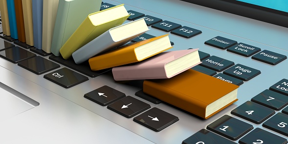 E-learning concept. Books stacked on a computer keyboard. 3d illustration