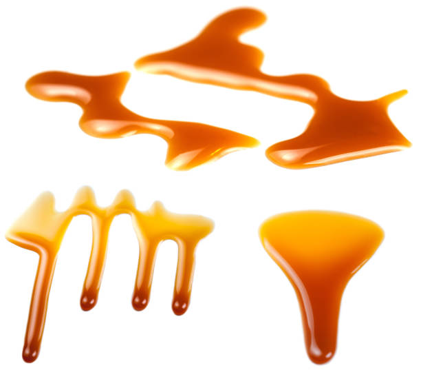istock Caramel splashes isolated on white background. Spilled caramel sauce, toffee toppings 1021650596