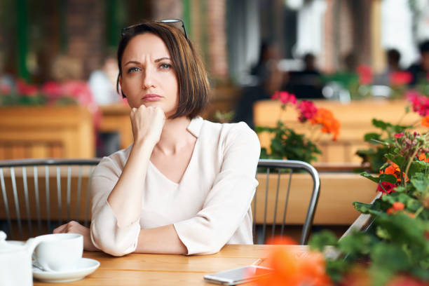 istock Young woman drinks coffee in cafeteria and posing with sunglasses 1021661072