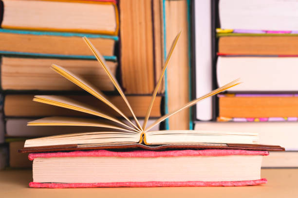 istock Open book, hardback books on bright colorful background. 1021661316