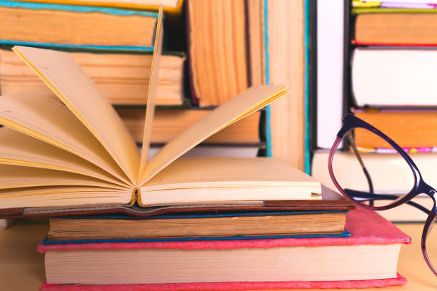 istock Open book, hardback books on bright colorful background. 1021661560