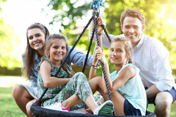 istock Joyful family having fun on playground 1021661734