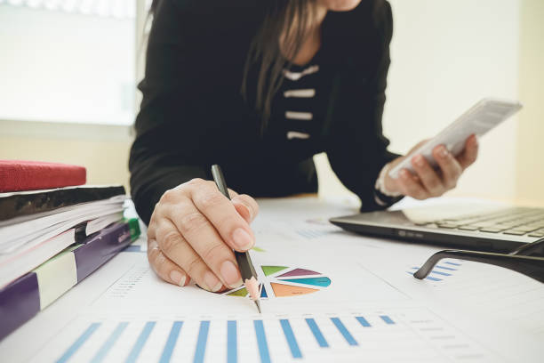 business using smartphone on office table with laptop computer and graph financial with social network diagram - spreadsheet financial figures computer computer monitor imagens e fotografias de stock