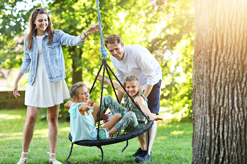 Picture showing joyful family having fun on playground