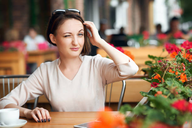 istock Young woman drinks coffee in cafeteria and posing with sunglasses 1021668044