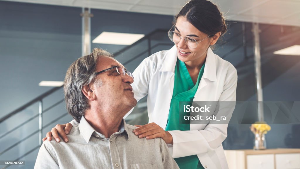 Health worker talking to the patient Doctor Stock Photo