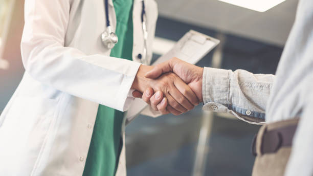 istock Health worker and patient shaking hands 1021670884