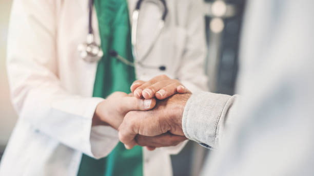 Health worker holding patient's hand Health worker holding patient's hand consoling stock pictures, royalty-free photos & images