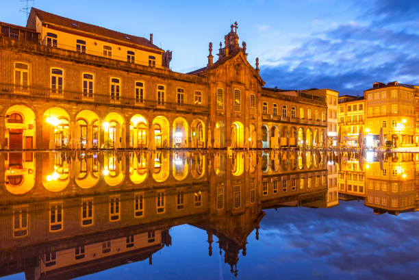 Exterior night view of Arcada (or Largo da Arcada) and the Church of Lapa (Igreja da Lapa), reflected in the fountain on Republic Square (Praca da Republica) in Braga, Portugal