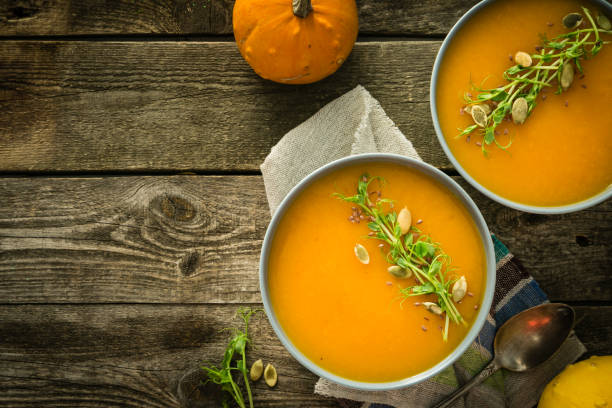 istock Pumpkin soup with pea micro green and seeds 1021684438