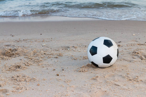 istock Soccer ball on the sand 1021684882