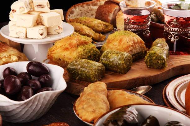istock Middle eastern or arabic dishes and assorted meze, concrete rustic background. sambusak. Turkish Dessert Baklava with pistachio. Sarma. Halal food. Lebanese 1021684996
