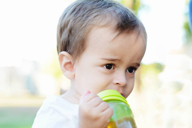 istock Cute Baby Boy Drinking Milk Bottle 1021694358