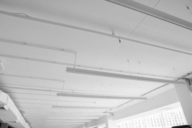istock Fluorescent long lamps of day light on the modern white ceiling. 1021706828