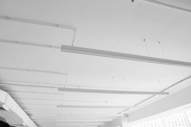 istock Fluorescent long lamps of day light on the modern white ceiling. 1021706848