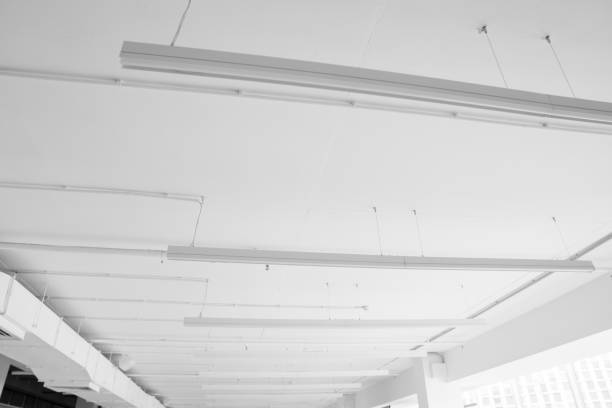 istock Fluorescent long lamps of day light on the modern white ceiling. 1021706850