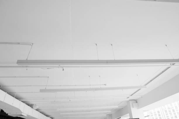 istock Fluorescent long lamps of day light on the modern white ceiling. 1021706868