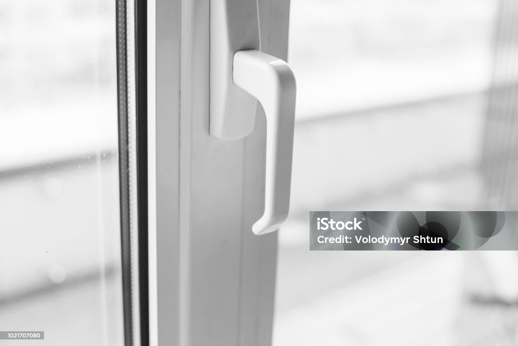 Close-up on a white handle of the pvc window. Close-up on a white handle of the pvc window Window Stock Photo