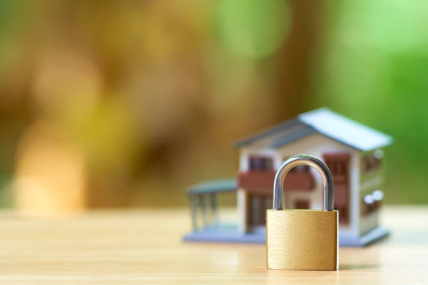 istock Model house wrapped with steel chain and padlock. Ideas Security. using as background business concept and Security concept with copy space. 1021715066