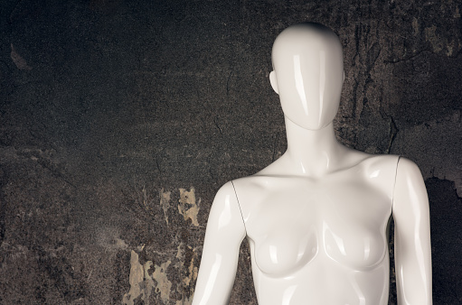 Close up of white mannequin dummy statue with cracks in it's fake plastic skin idea of beauty skin deep
