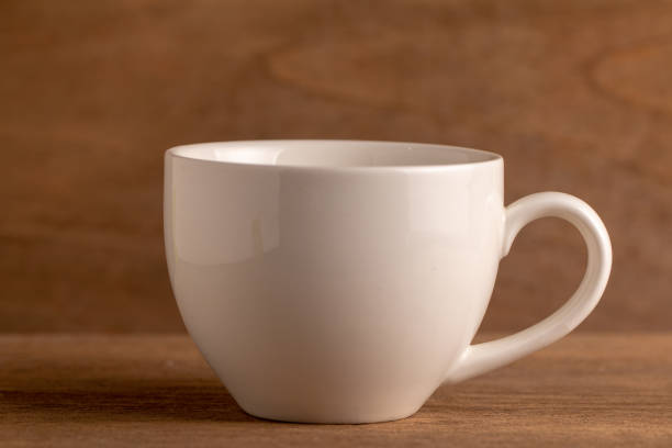 istock Empty vintage coffee cup with floral pattern on an old wooden table, selective focus. Image with copy space. 1021722328