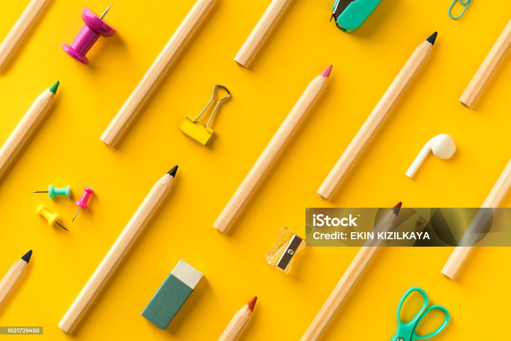 School supplies and coloring pencils flat lay on yellow background Diagonally arranged school supplies and coloring pencils  on yellow background. Back to school colorful flat lay School Supplies Stock Photo