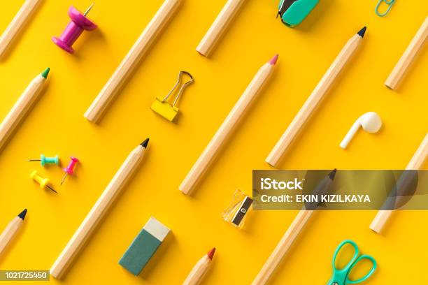 School Supplies And Coloring Pencils Flat Lay On Yellow Background Stock Photo - Download Image Now