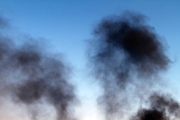 istock dark smoke pillar on the blue sky background. 1021734072