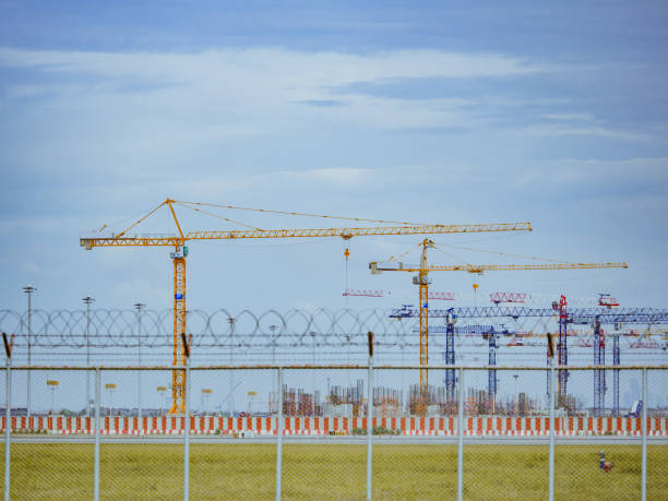 istock travel and transportation concept from big yellow construction crane during work from runway with blue sky and cloud background 1021735810