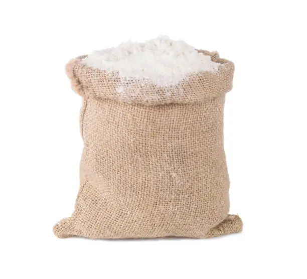 flour in burlap sack bag isolated on white background