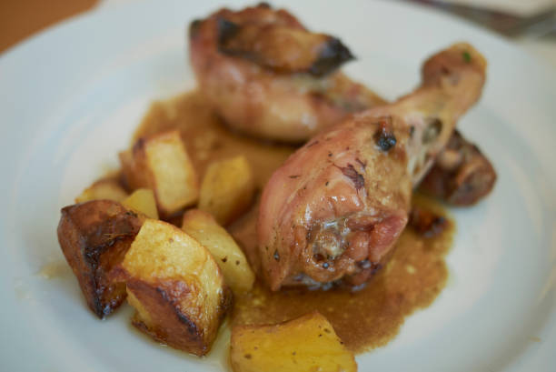 istock Chicken legs and roasted potatoes 1021736804