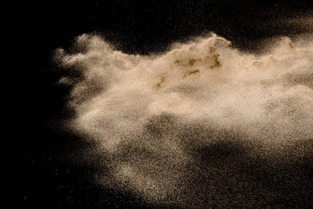 istock Golden sand explosion isolated on black background. Abstract sand cloud. 1021737294
