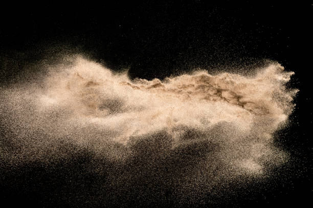 istock Golden sand explosion isolated on black background. Abstract sand cloud. 1021737374