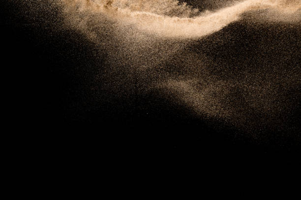istock Golden sand explosion isolated on black background. Abstract sand cloud. 1021737378