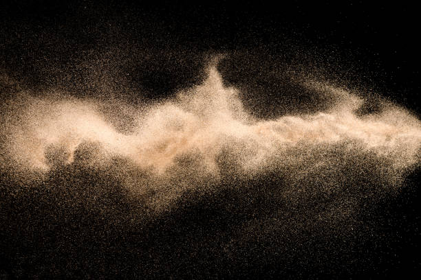 istock Golden sand explosion isolated on black background. Abstract sand cloud. 1021737382