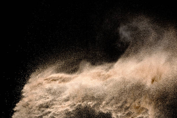 istock Golden sand explosion isolated on black background. Abstract sand cloud. 1021737434