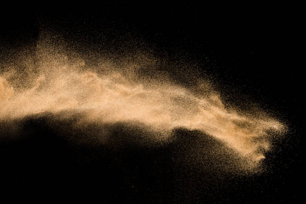 istock Golden sand explosion isolated on black background. Abstract sand cloud. 1021737446