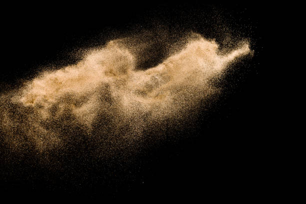istock Golden sand explosion isolated on black background. Abstract sand cloud. 1021737464