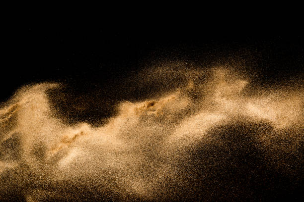 istock Golden sand explosion isolated on black background. Abstract sand cloud. 1021737500