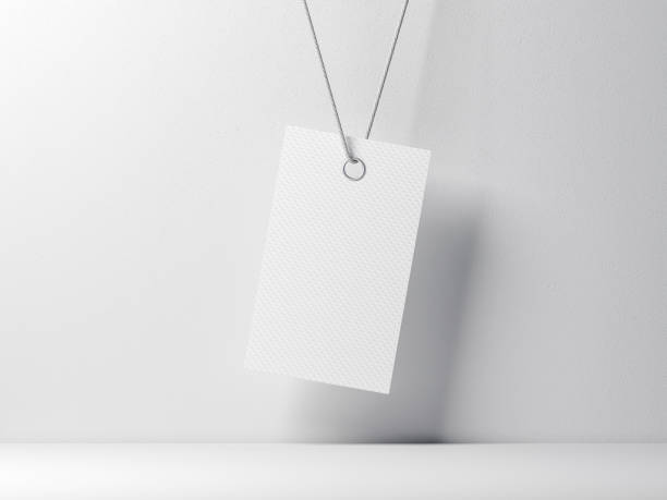 istock Empty tag label Mockup tied on rope against white wall 1021757856