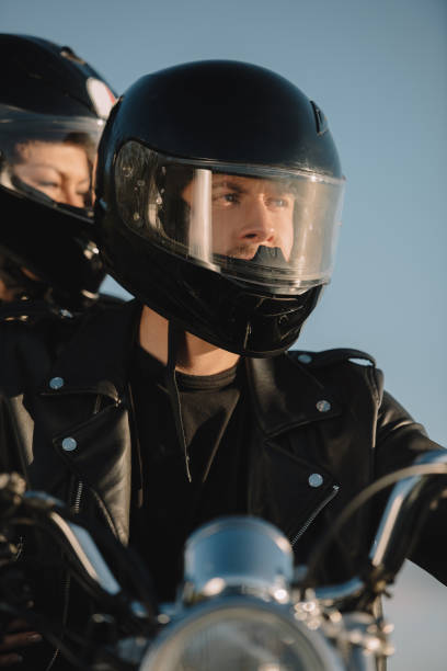 istock two bikers in moto helmets sitting on motorcycle 1021758500