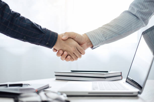 Business partnership meeting concept, Two confident Business handshake and business people after discussing good deal of Trading contract and new projects for both companies, success, partnership stock photo